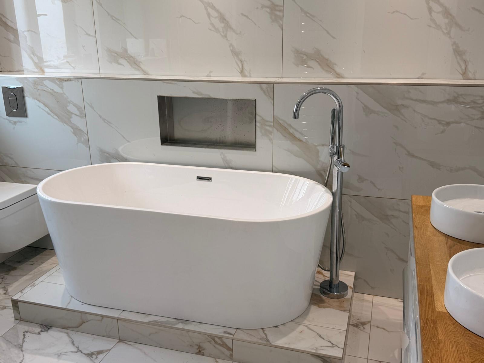 Freestanding bath with a chrome floor-standing tap